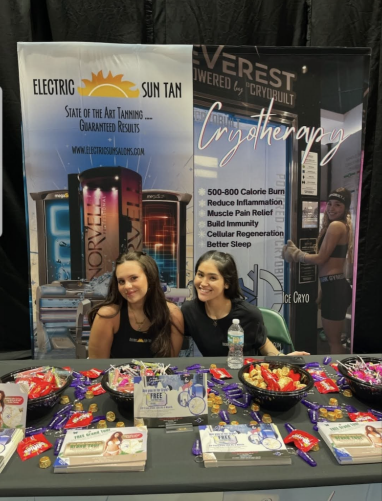 Two women sitting at a table with some candy.
